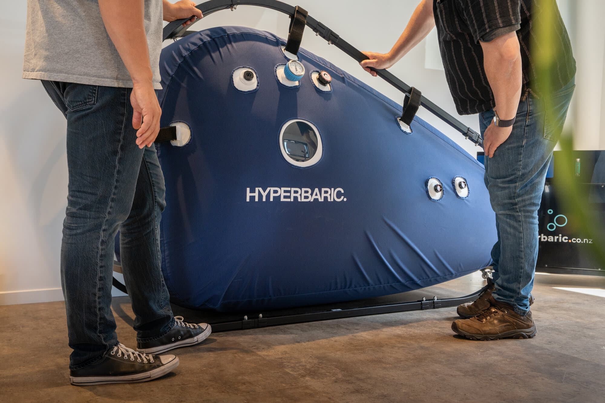 Hyperbaric chamber showing branded exterior and viewing ports