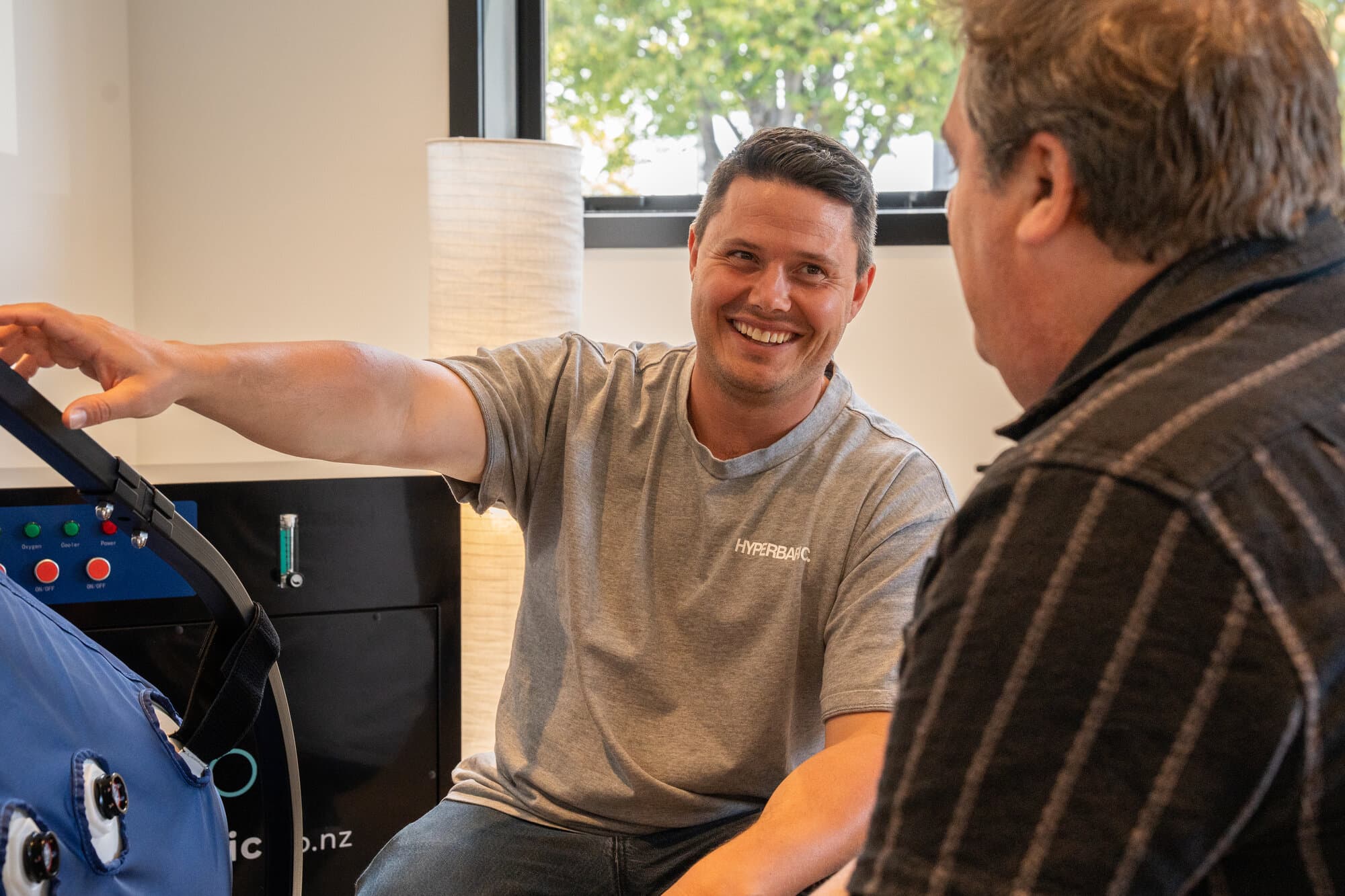 Callum explaining hyperbaric chamber operation to a customer
