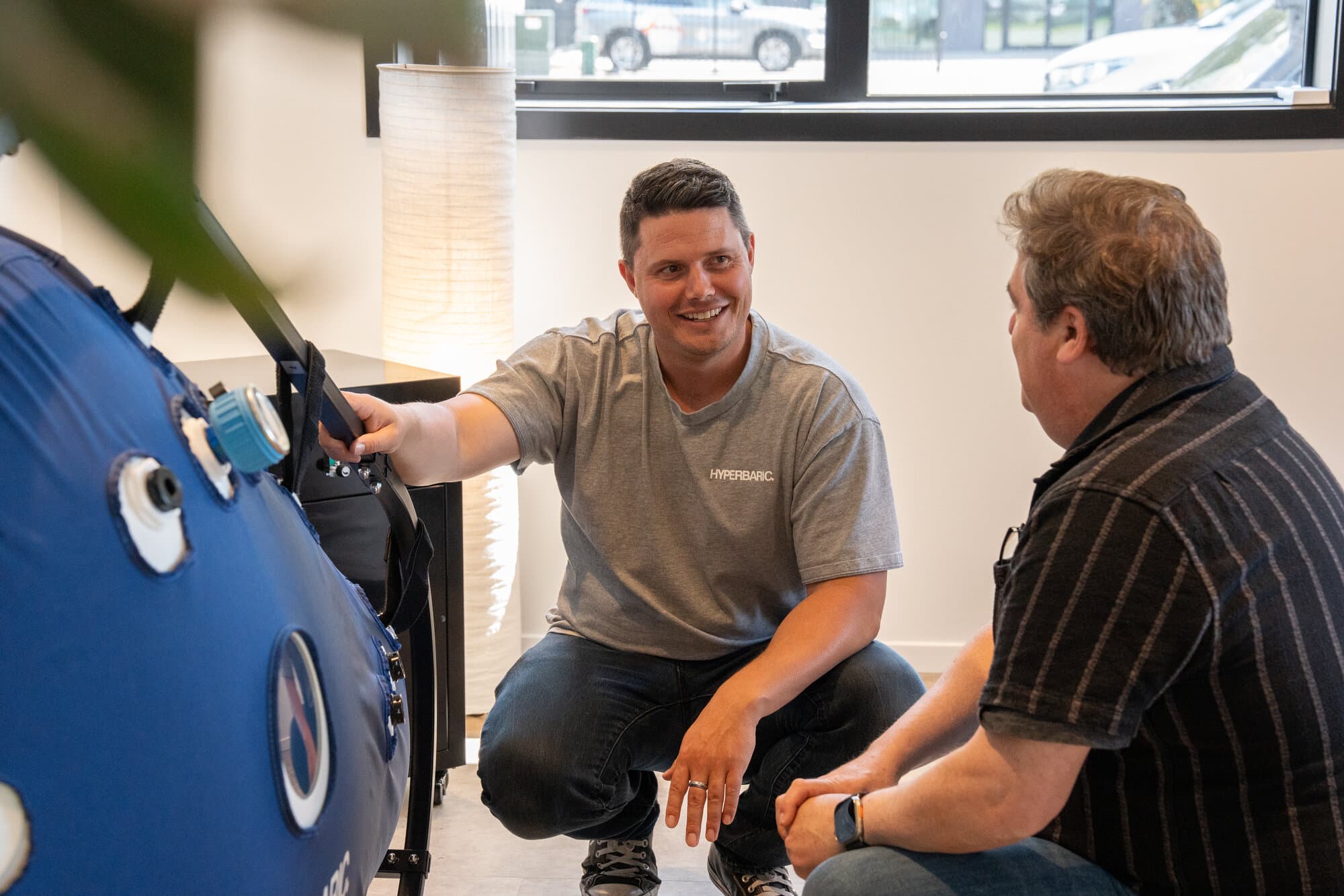 Callum demonstrating hyperbaric chamber features to a customer