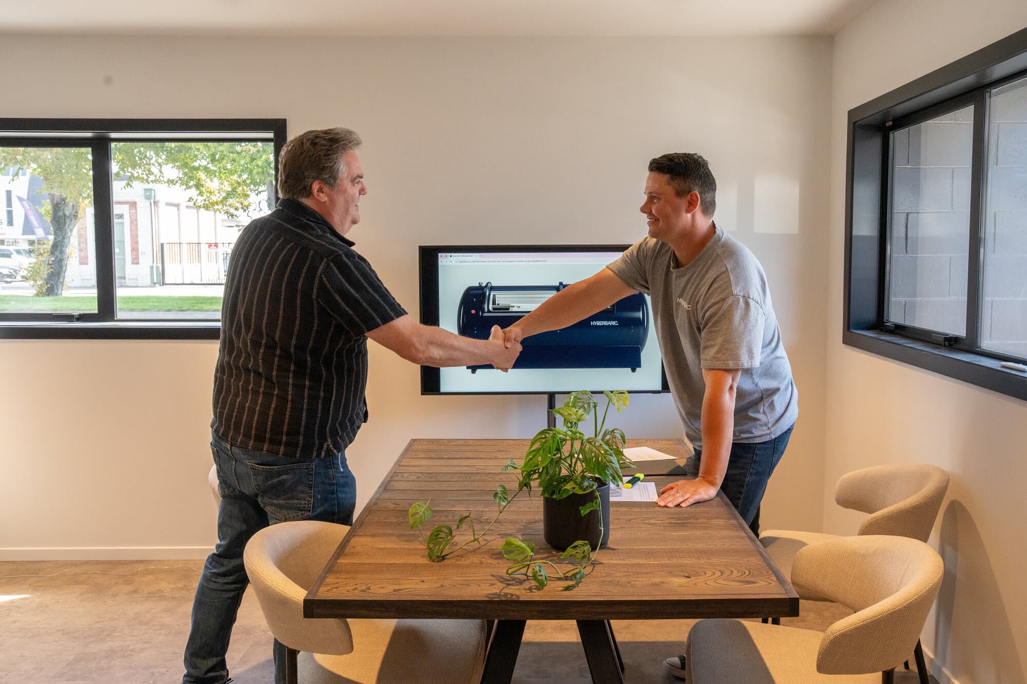 Customer and Callum shaking hands after a successful consultation